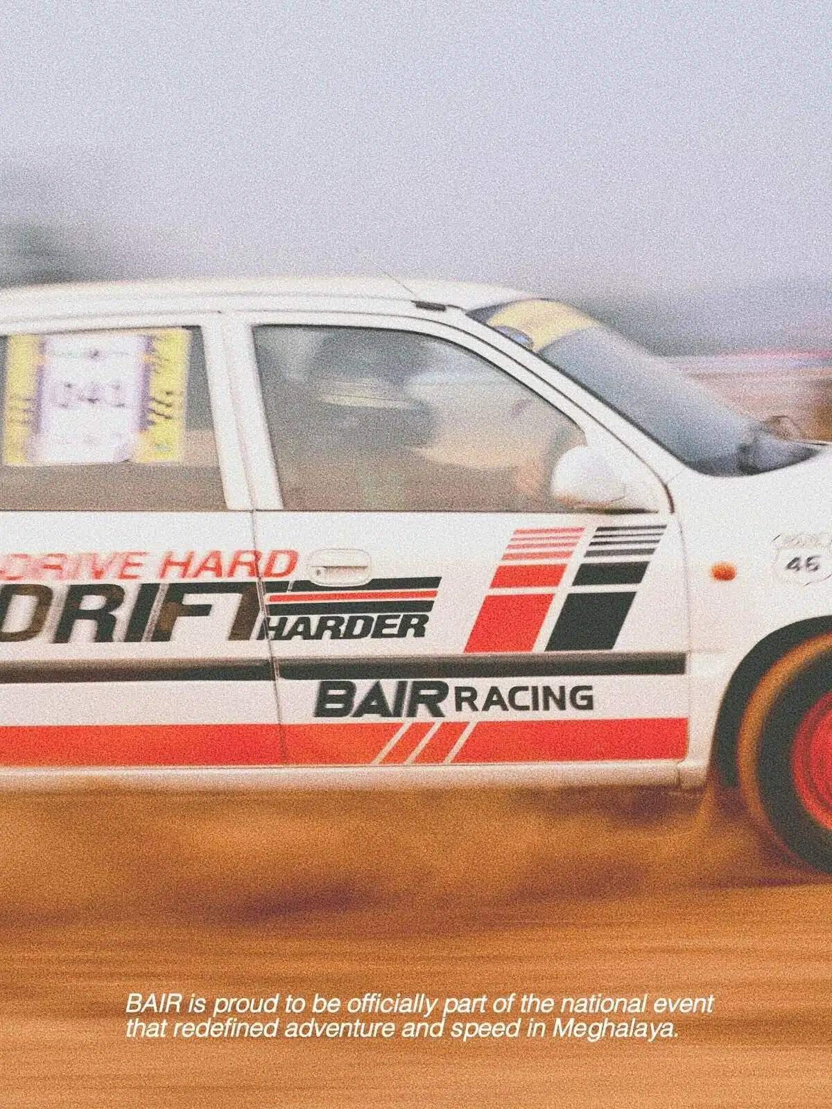 Rally car racing on dirt track with motion blur and dust clouds.
